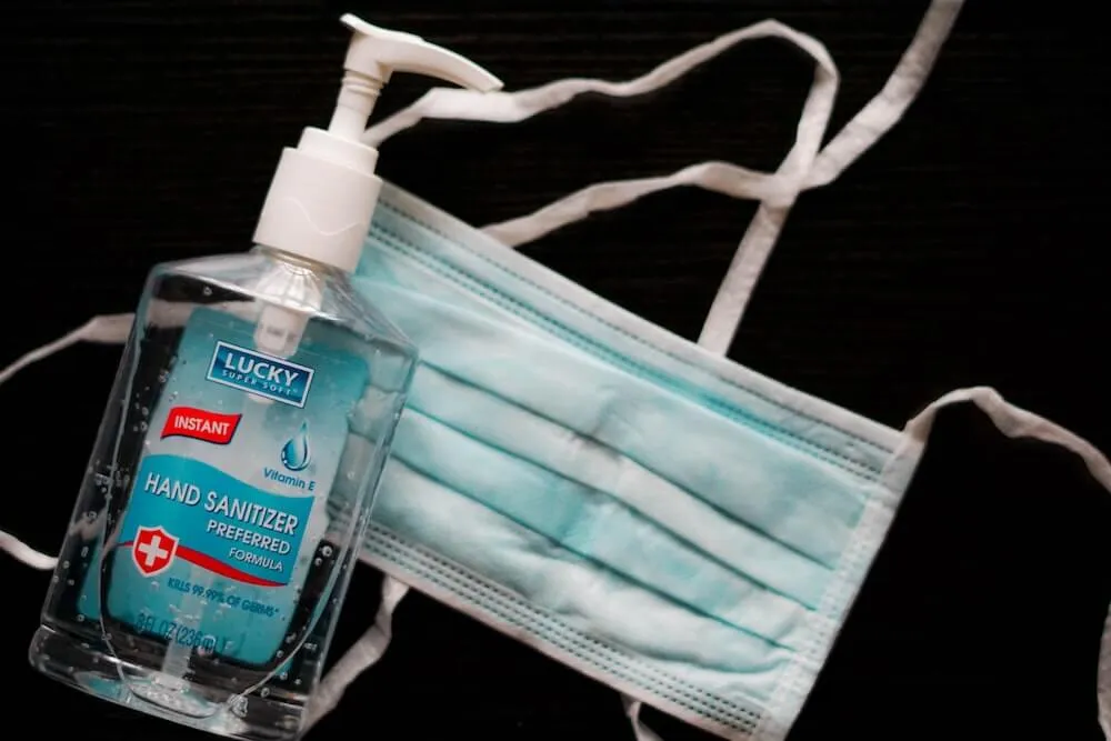 Blue hand sanitiser pump bottle and mask